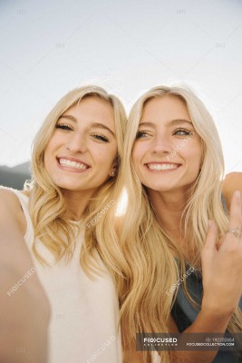 focused_192202454-stock-photo-two-blonde-teenage-girls-lake.jpg